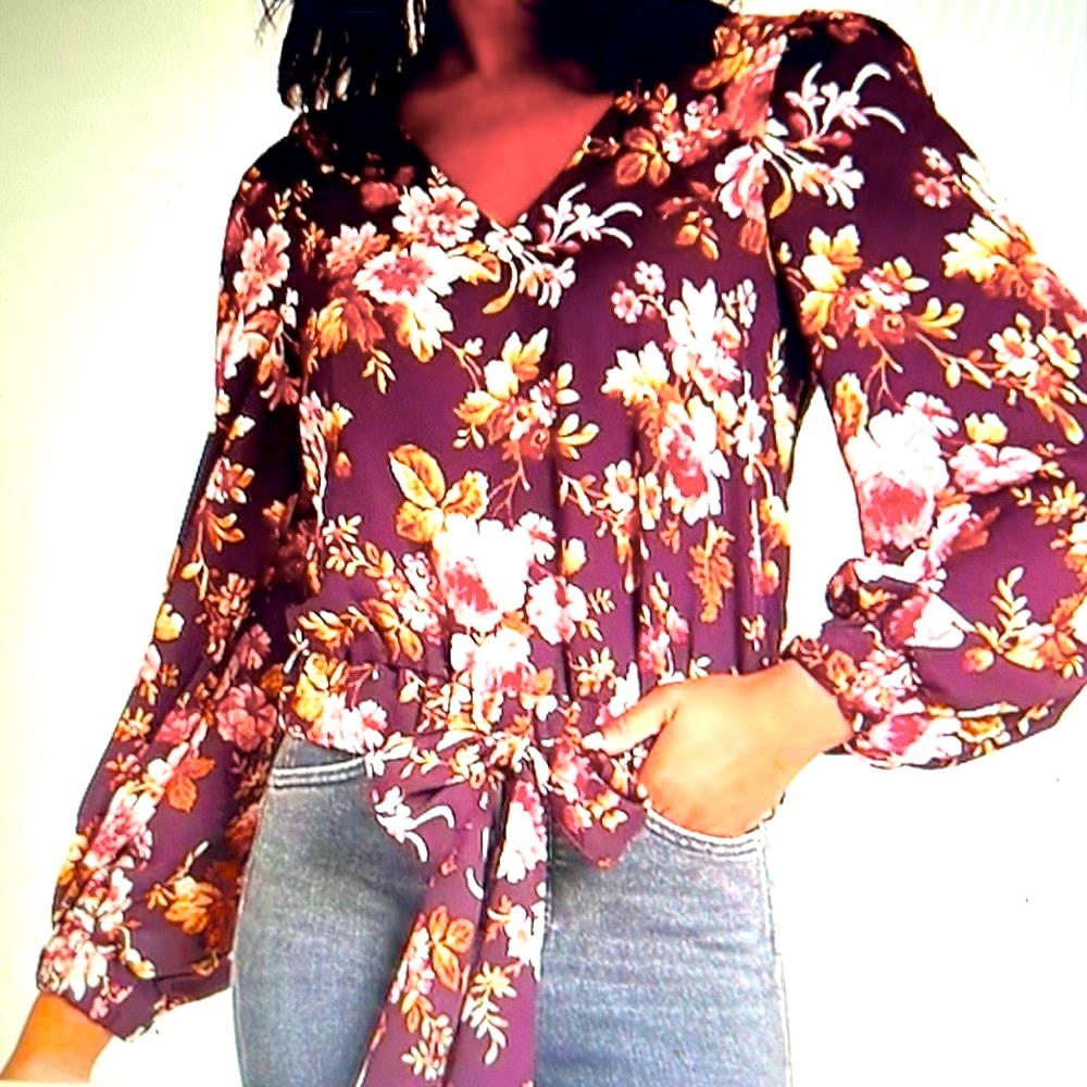 Beautiful floral blouse featuring v-neck, long balloon sleeves & bow tied waist